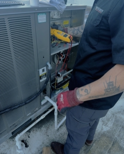 HVAC technician diagnosing whether AC repair or replacement is best in Carlsbad CA