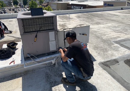 HVAC technician diagnosing an AC system not cooling