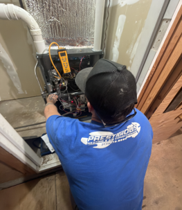 Technician diagnosing a furnace for no-heat repair in Encinitas CA