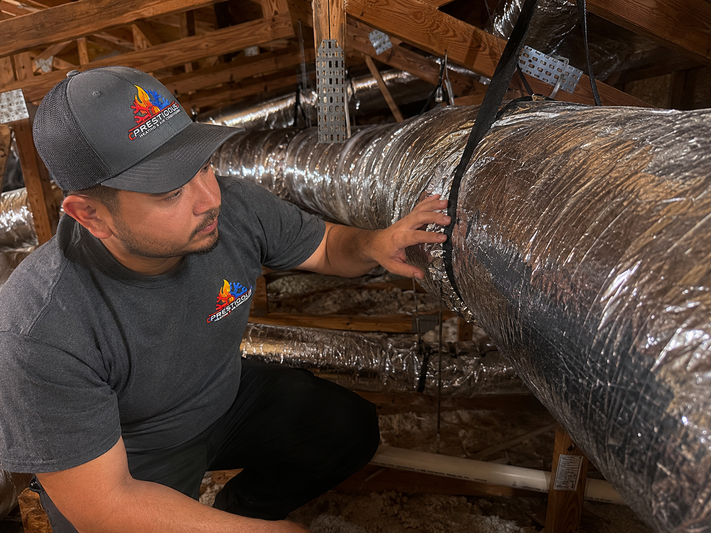 HVAC technician inspecting attic ductwork condition before HVAC replacement in Carlsbad CA