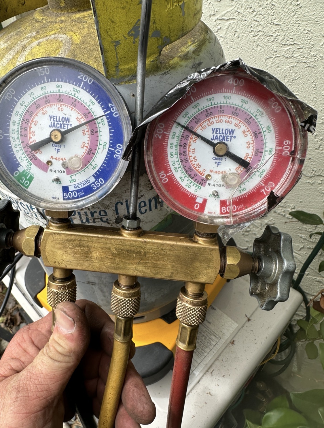HVAC technician checking refrigerant pressures during AC cooling diagnostic in Carlsbad CA