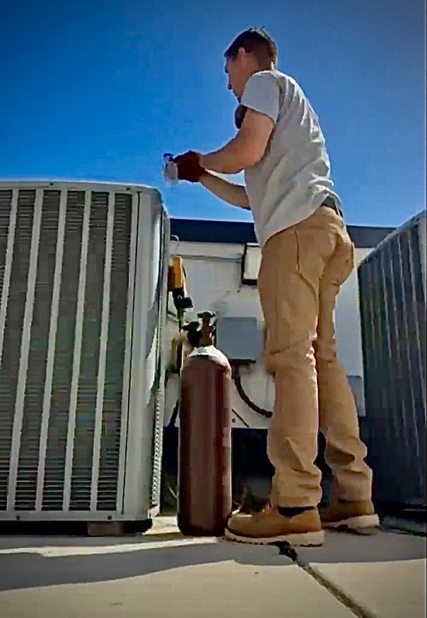 HVAC technician performing honest diagnostic service on AC system in Carlsbad CA