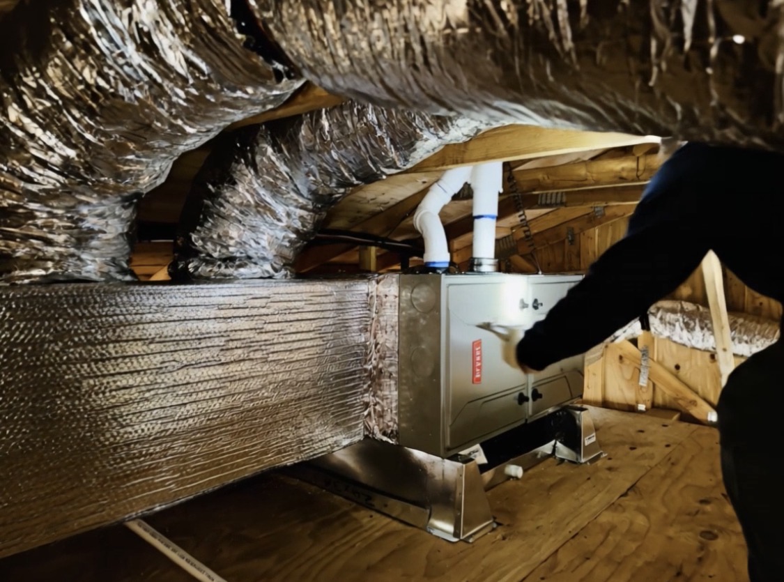 HVAC technician inspecting ductwork that may limit new HVAC system performance in Carlsbad